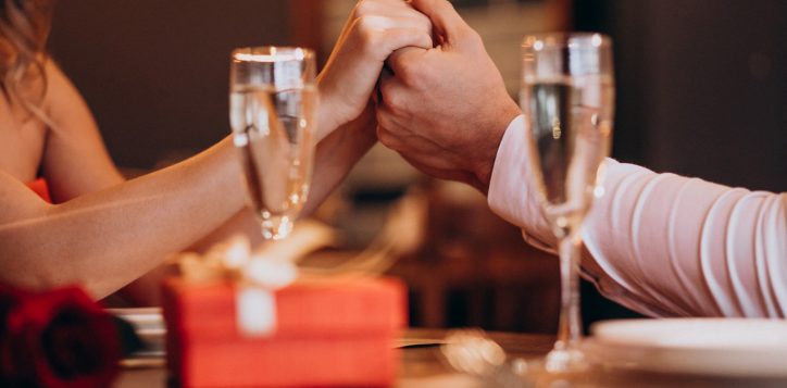 couple-holding-hands-valentines-evening-restaurant-2